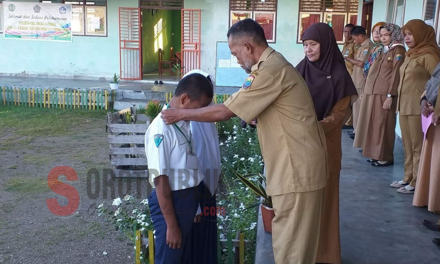 Kepala DLH yang juga mantan Kepala BKD Kabupaten Seram Bagian Barat (SBB), Leo Kakisina mengalungkan kartu peserta pada Pembukaan Sampul UNBK di MTs. Al Ikhlas Kelapa Dua, Kairatu. (Foto: Fitra/SorotPublik)